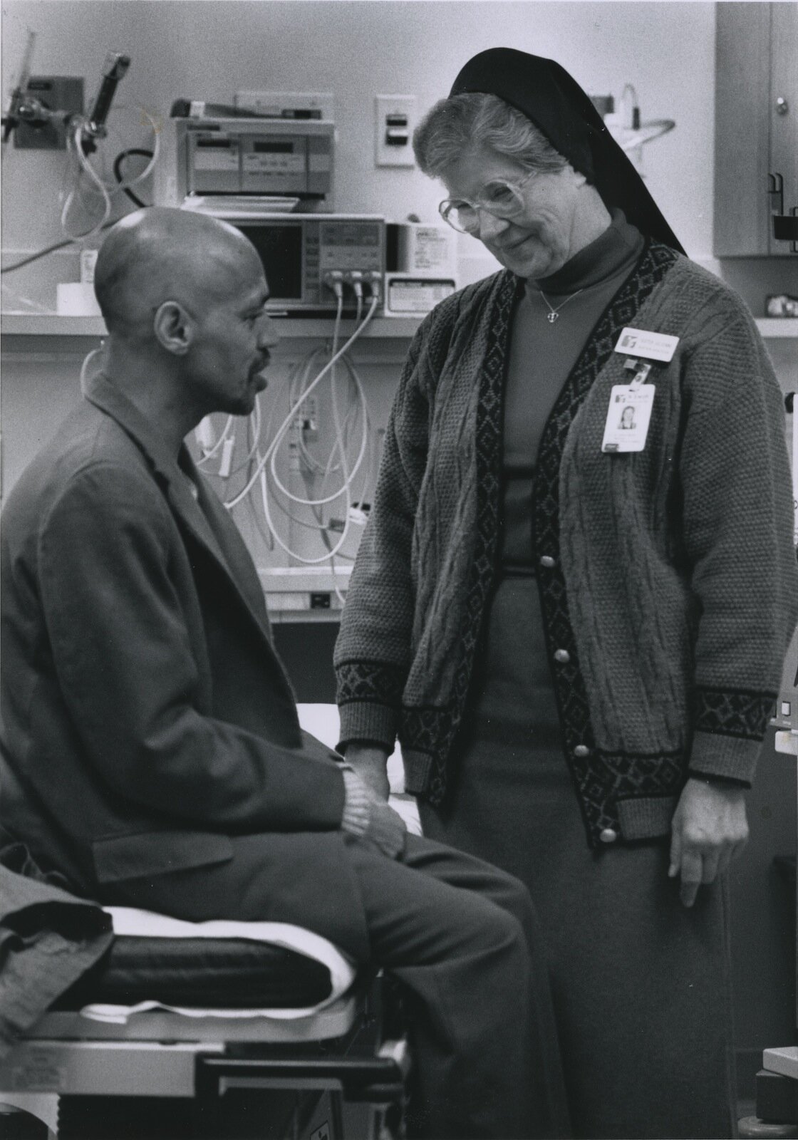 Sister Julienne Smith visiting with people at the hospital.