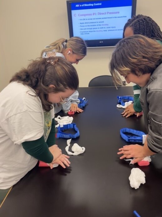 Public Health Student Heroes get hands-on training during a Stop the Bleed certification class.