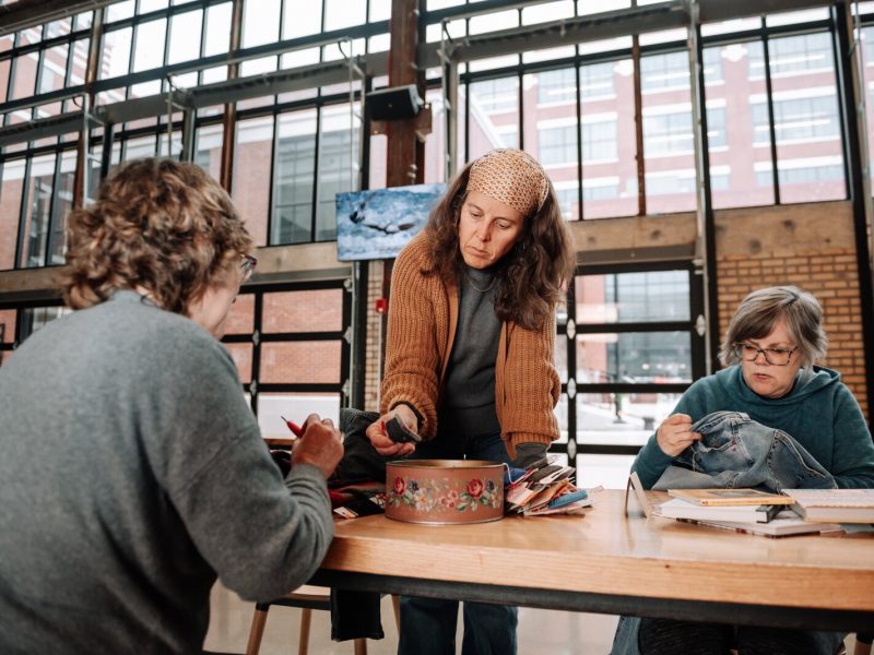 From left: Jennie Renner, Megan Burton, and Mia Morris work on mending projects.