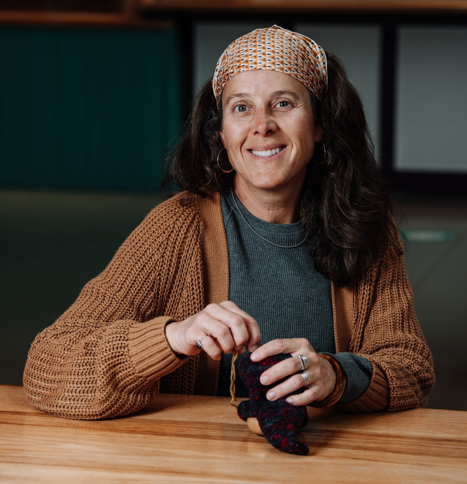 Megan Burton works on mending a sock.