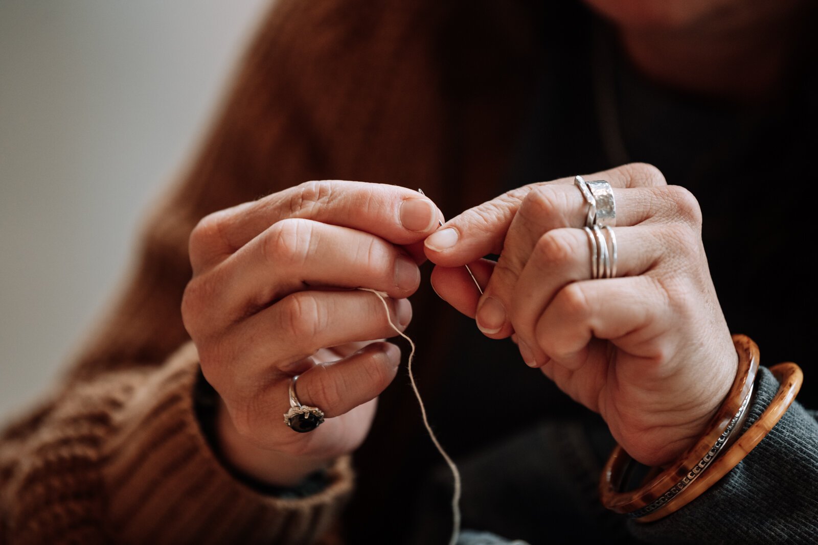 Megan Burton threads a needle.