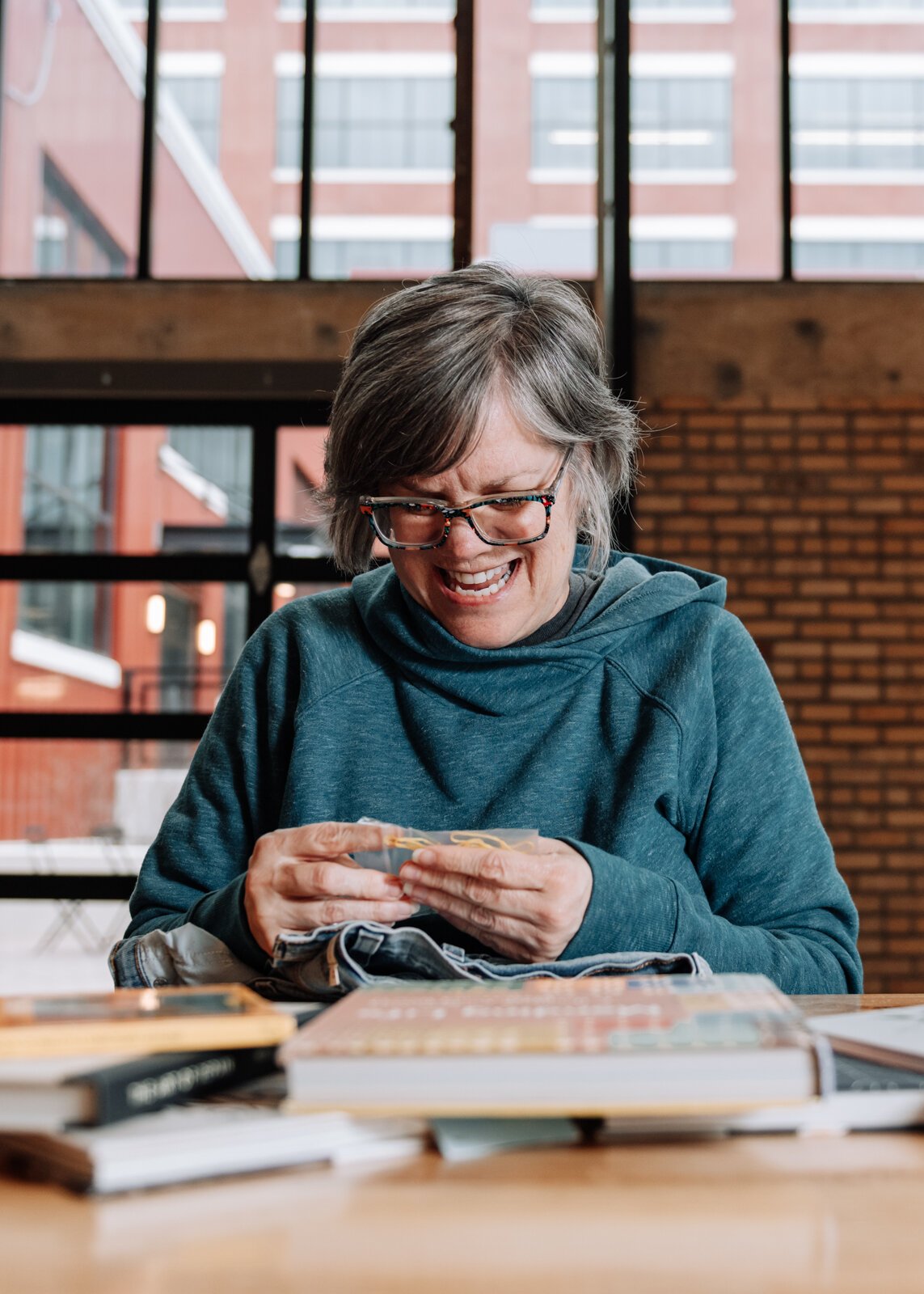 Mia Morris works on embroidering a pair of jeans.