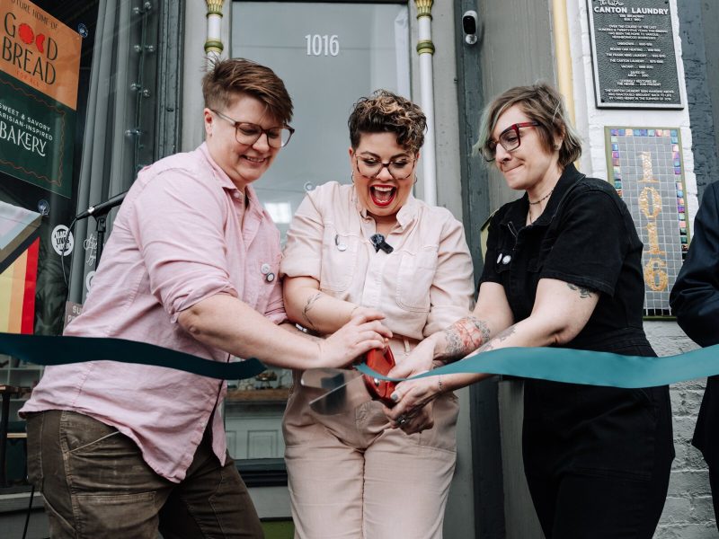 From left: Hilary Hontz, Sarah Thompson, and Mandy Hall cut the ribbon during the grand opening of Good Bread for All.