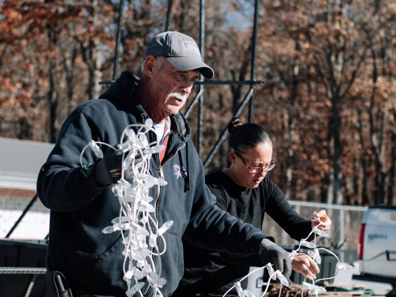 Field Team Supervisor Tom West, left, and Amanda Lapham work together to set up lights.