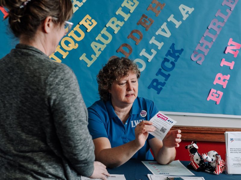 Betsy Kachmar, Co-President of League of Women Voters of Fort Wayne, right,  talks with Chris Castaldi about voting at the Allen County Public Library Tecumseh branch.