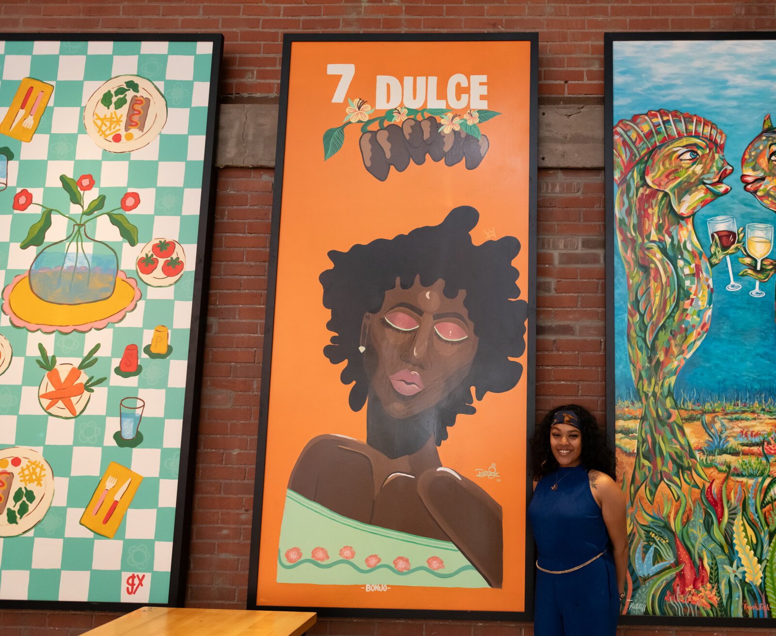 Local artist BonJo in front of her piece "7 Dulce" at Union Street Market at Electric Works.