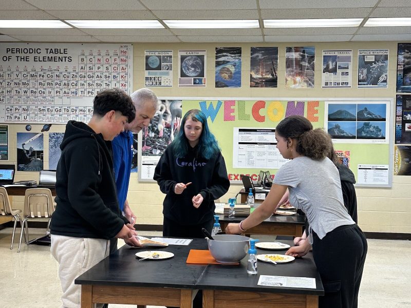 Students in Mr. Larsen's class add toppings to their quesadillas as part of the Cooking in the Classroom program.