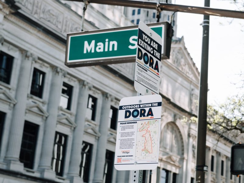 A sign at Main Street and Calhoun Street reminds people of the rules within the new Downtown DORA (Designated Outdoor Refreshment Area).