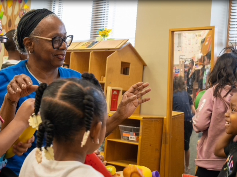 Orca, a foster grandparent, plays with the preschoolers in their classroom.