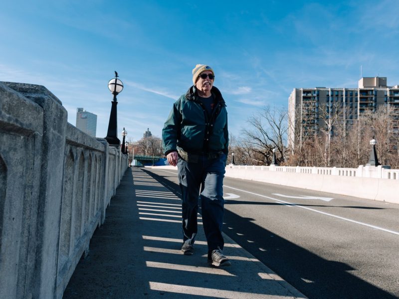 Mike Roeger walks the bridge on Saint Joe Boulevard near Conjure Coffee in Fort Wayne.