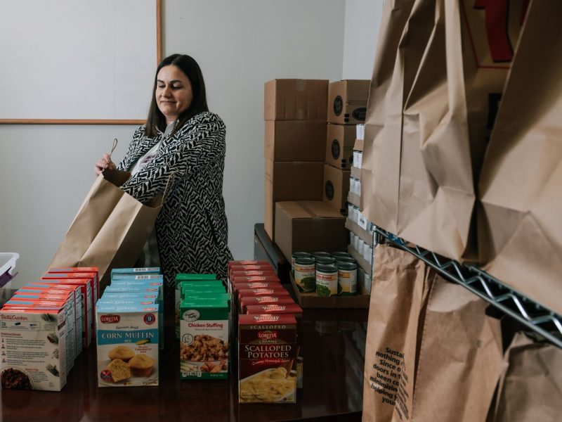 Ermina Mustedanagic, CEO of Wellspring packs a holiday bag at the foodbank at Wellspring Interfaith Social Services.