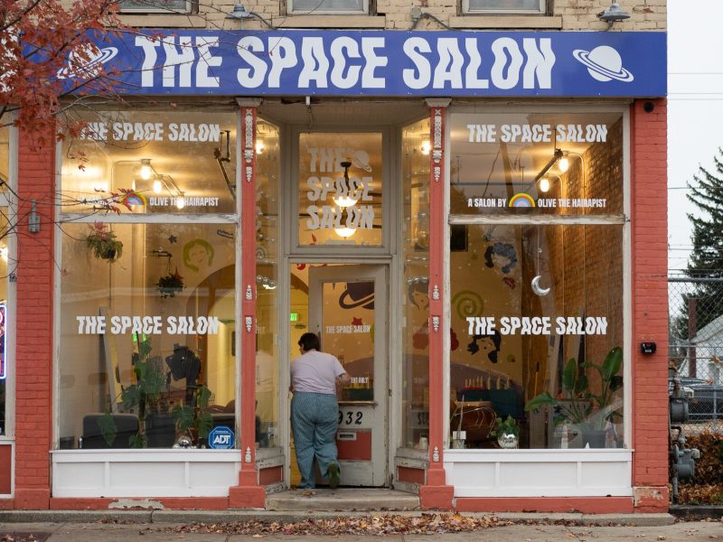 Olive enters the front door of The Space Salon on South Calhoun Street.