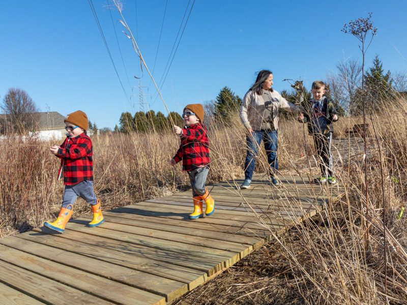 Families explore the prairie outside of Stillwater Hospice.