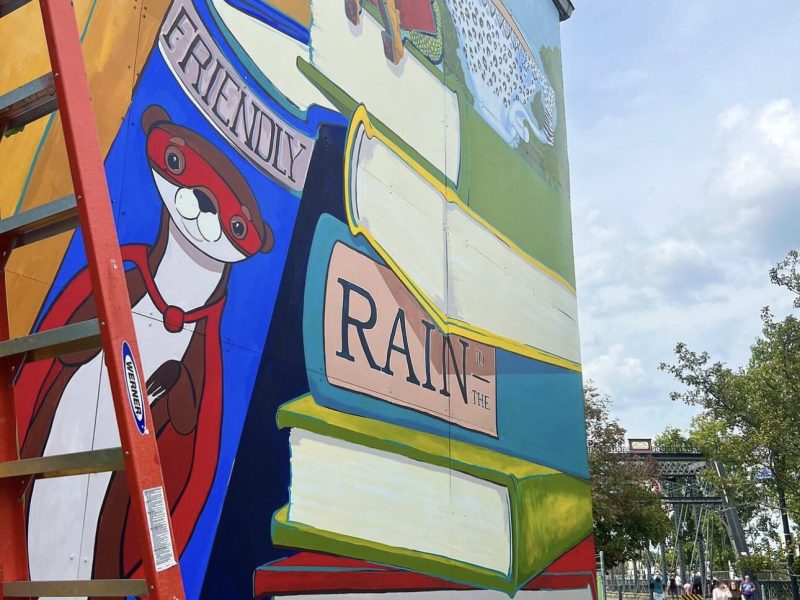A new “Only Rain in the Drain” mural from Alexandra Hall is currently in progress at TJ Nowak Supply.