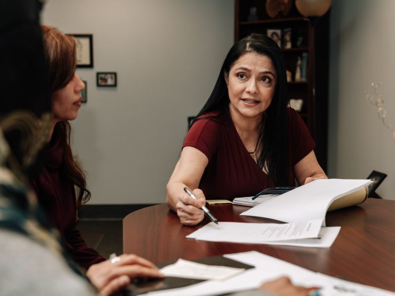 Luz Ostrognai with Catholic Charities demonstrates what a meeting with immigration clients would look like at the Archbishop Noll Catholic Center.