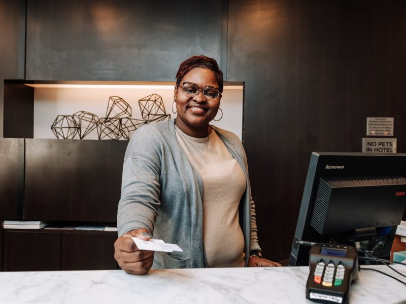Letha Hill, Front Desk Attendant, hands out a key card during her shift at Courtyard by Marriott in Downtown Fort Wayne.
