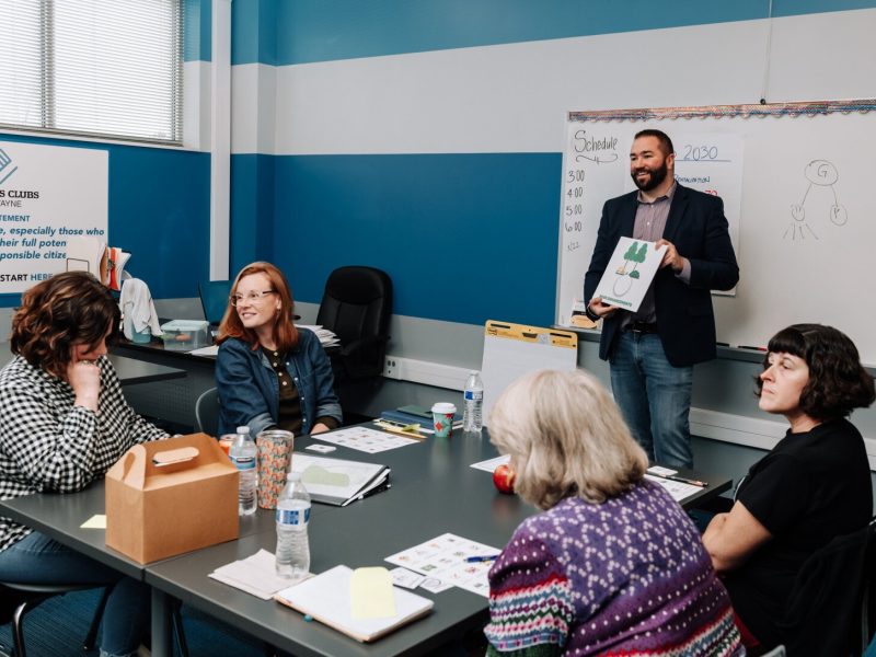 Dan Baisden talks with residents during the Packard Area Planning Alliance retreat at the Boys and Girls Club on Fairfield Ave.