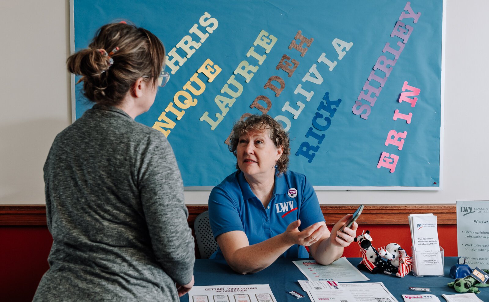 Betsy Kachmar, Co-President of League of Women Voters of Fort Wayne, right, talks with Chris Castaldi about voting at the Allen County Public Library Tecumseh branch.