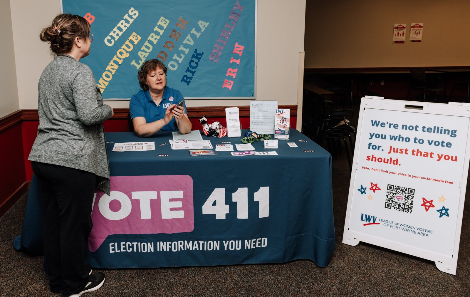 Betsy Kachmar, Co-President of League of Women Voters of Fort Wayne, right, talks with Chris Castaldi about voting at the Allen County Public Library Tecumseh branch.