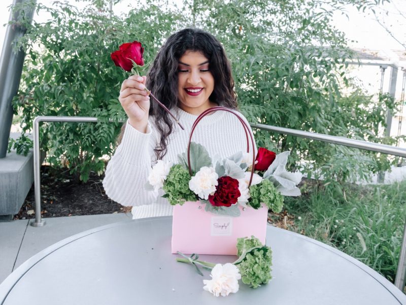 Samantha Cazares of Simply Charming works on arranging The Floral Purse.