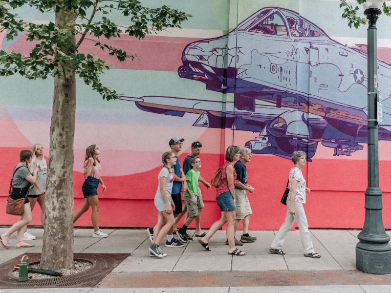 A group of Art Crawl attendees walk to another location Downtown.