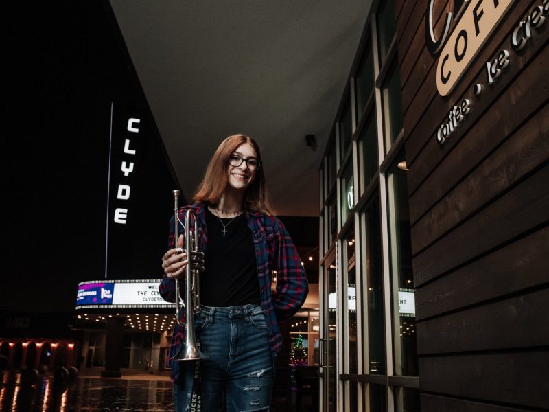 Amara Marion, an eighth grader at Memorial Park, poses with her trumpet at a hotspot for local music in Fort Wayne, the Clyde Theatre, Club Room, and Crescendo Coffee & More.