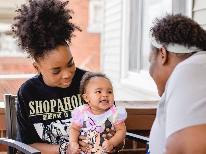 Home visits are a key part of Healthier Moms and Babies' programs. Here a home visitor chats with a mom and her baby.