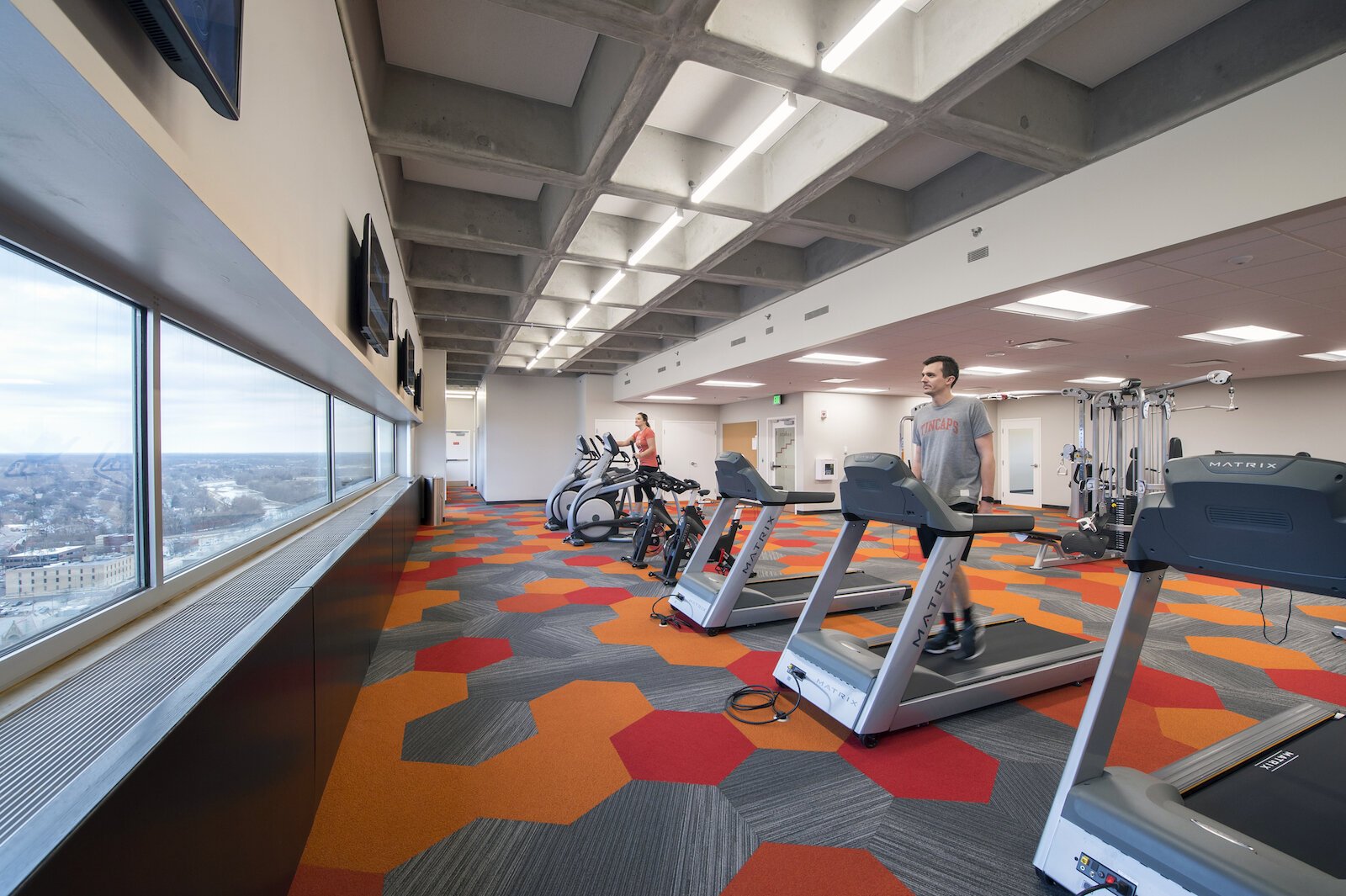 At Indiana Michigan Power Center’s Corporate Headquarters in Fort Wayne, Design Collaborative designed a fitness studio for employees that overlooks the outdoors.
