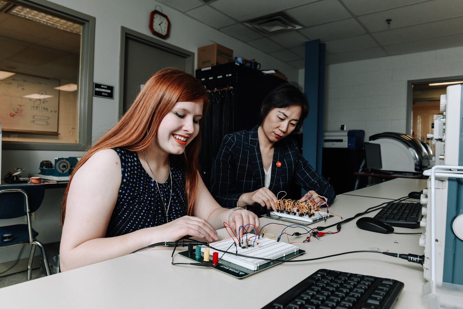 Indiana Tech student Alexandra Forsythe, left, and Dr. Ying Shang, Dean of the Talwar College of Engineering and Computer Sciences work together on operational amplifier functions in the Zollner Engineering Center.