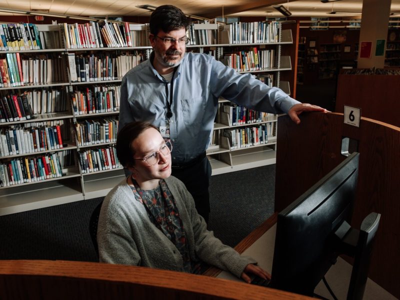 Branch Manager Christopher R. Wiljer helps Librarian Kristina Lay with the computer at the Allen County Public Library's Monroeville branch.