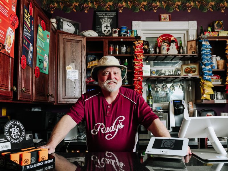 Rudy Mahara behind the counter at Rudy's Cigar Shop.