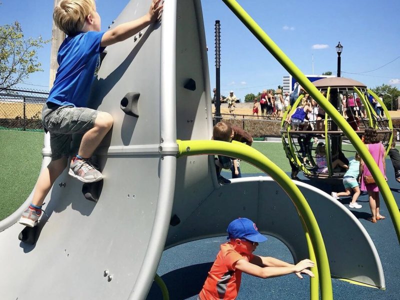 Children climb up playground equipment at the PNC Playground Riverfront Fort Wayne’s Promenade Park.
