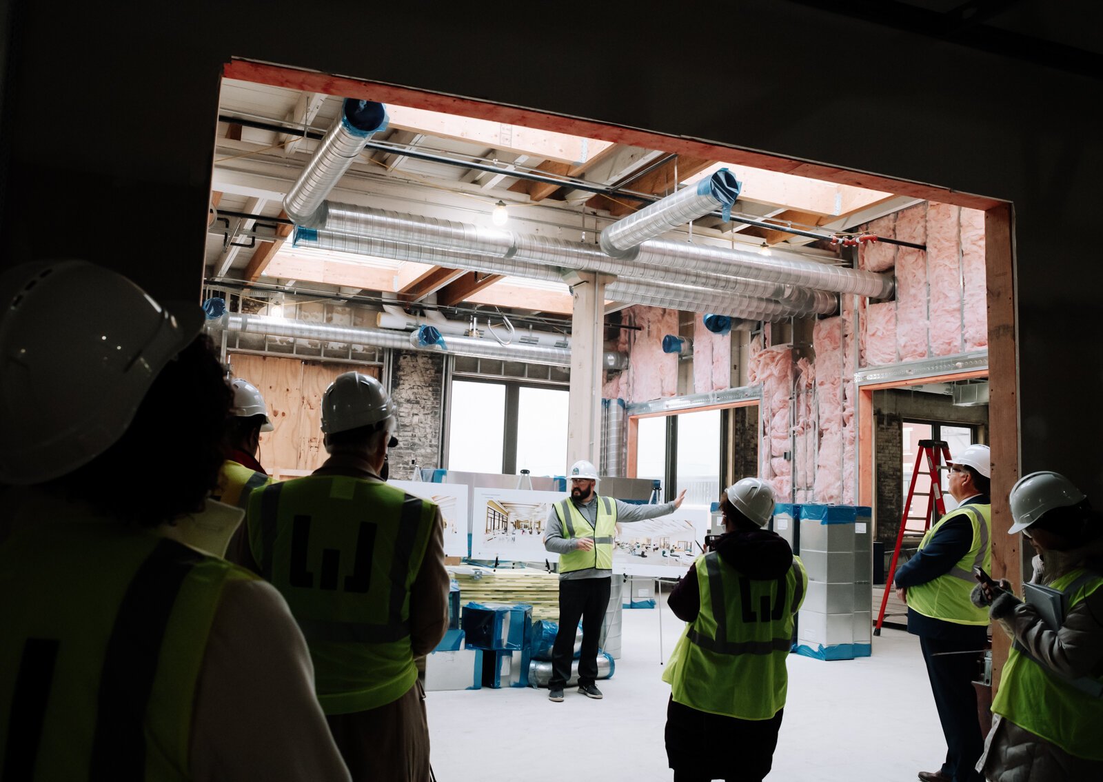 Riley Johnson, Director of the Amp Lab at Fort Wayne Community Schools, speaks with members of the media inside the Amp Lab's future space in Building 31 of Electric Works. (December 2021)