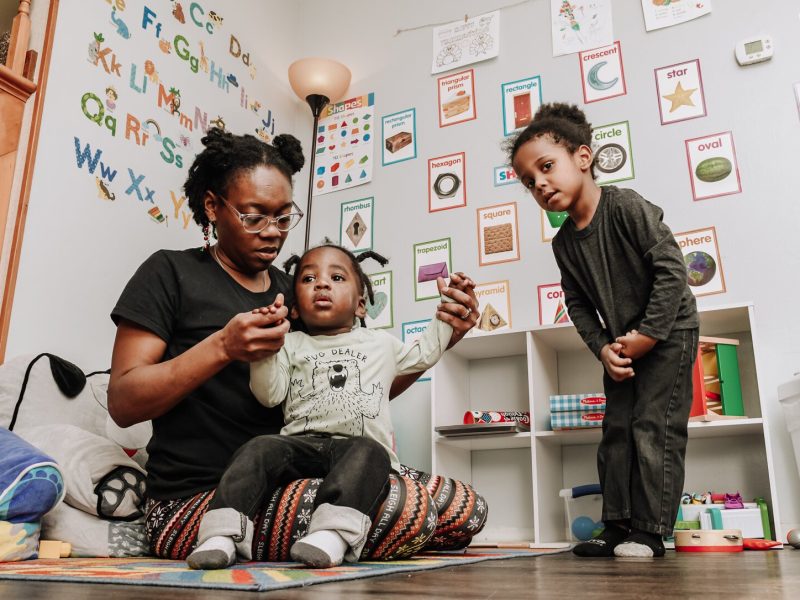 Deondra Steward, Owner of Unique Cherubs takes care of children, JereMias, left, and Domonique.