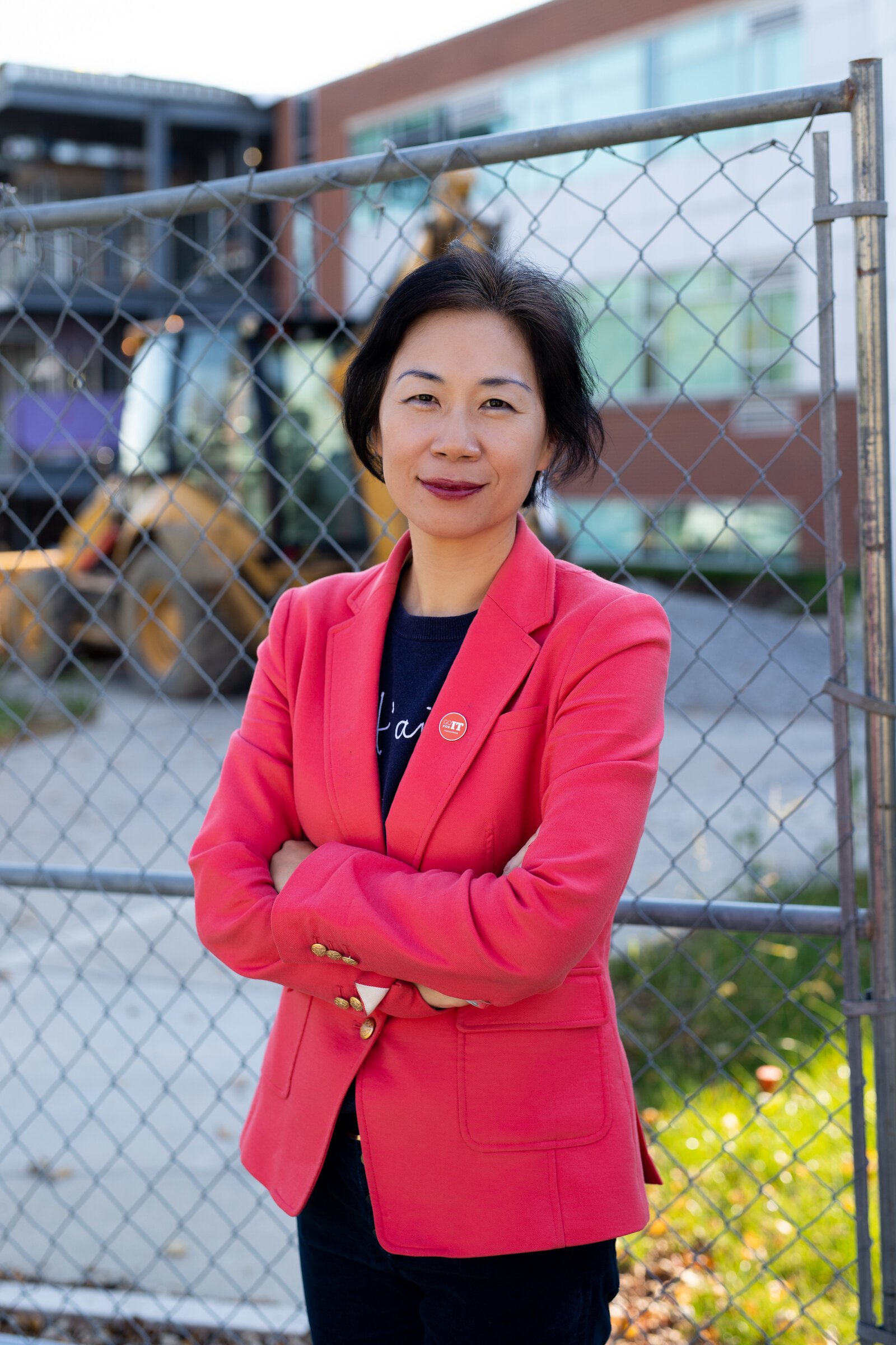 Dr. Ying Shang stands in front of the Zollner Engineering Center at Indiana Tech, which is under construction to double its size.
