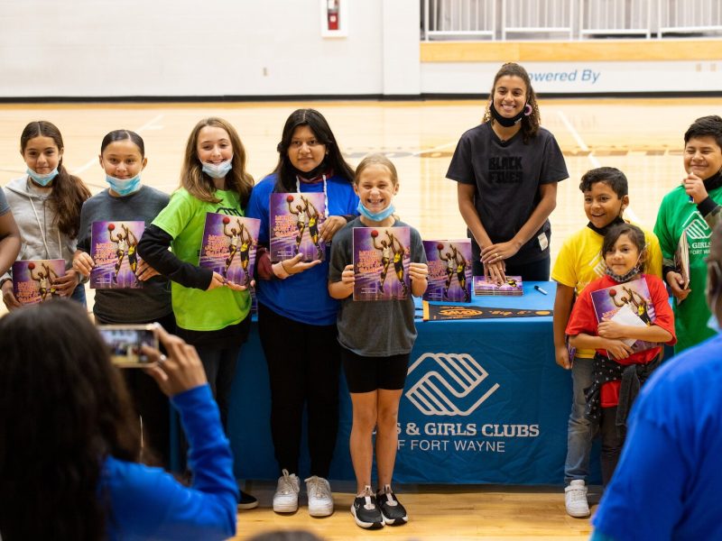Madison Moore, a Fort Wayne-raised author of "More Than Just a Game: The Black Origins of Basketball," signs copies of her book at the Fort Wayne Boys & Girls Club.