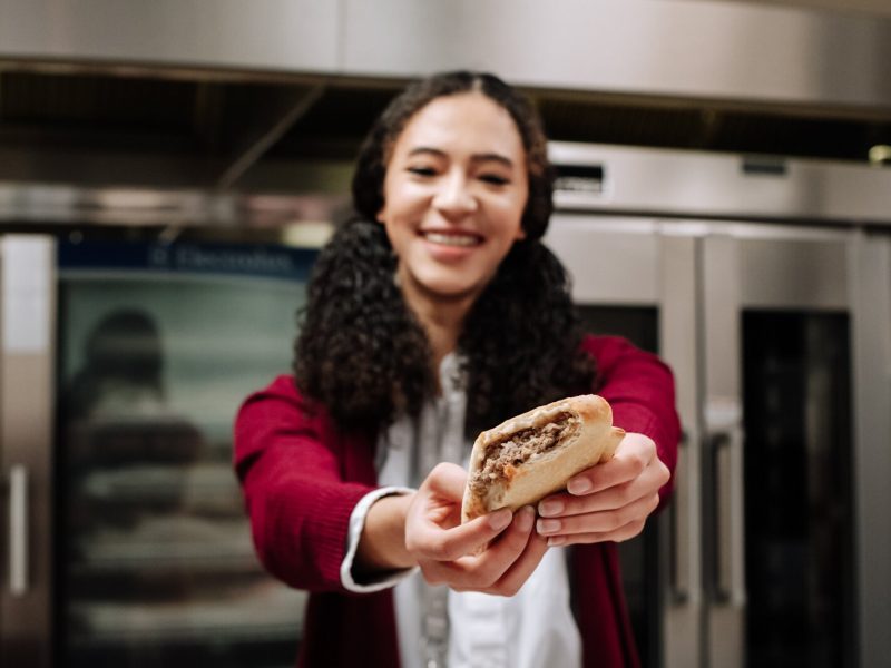 Senior Morgan Metzger at Manchester Junior-Senior High School taste tests sausage bread made with local pork from 4-H as part of the school's Farm to School efforts.