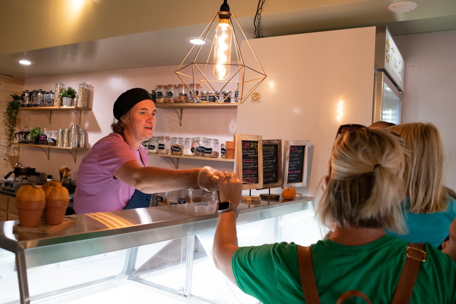 Julie Hurd, owner at Moo-Over Ice Cream, 207 W. Van Buren St. in Columbia City, helps the Girardot family select a flavor of ice cream.