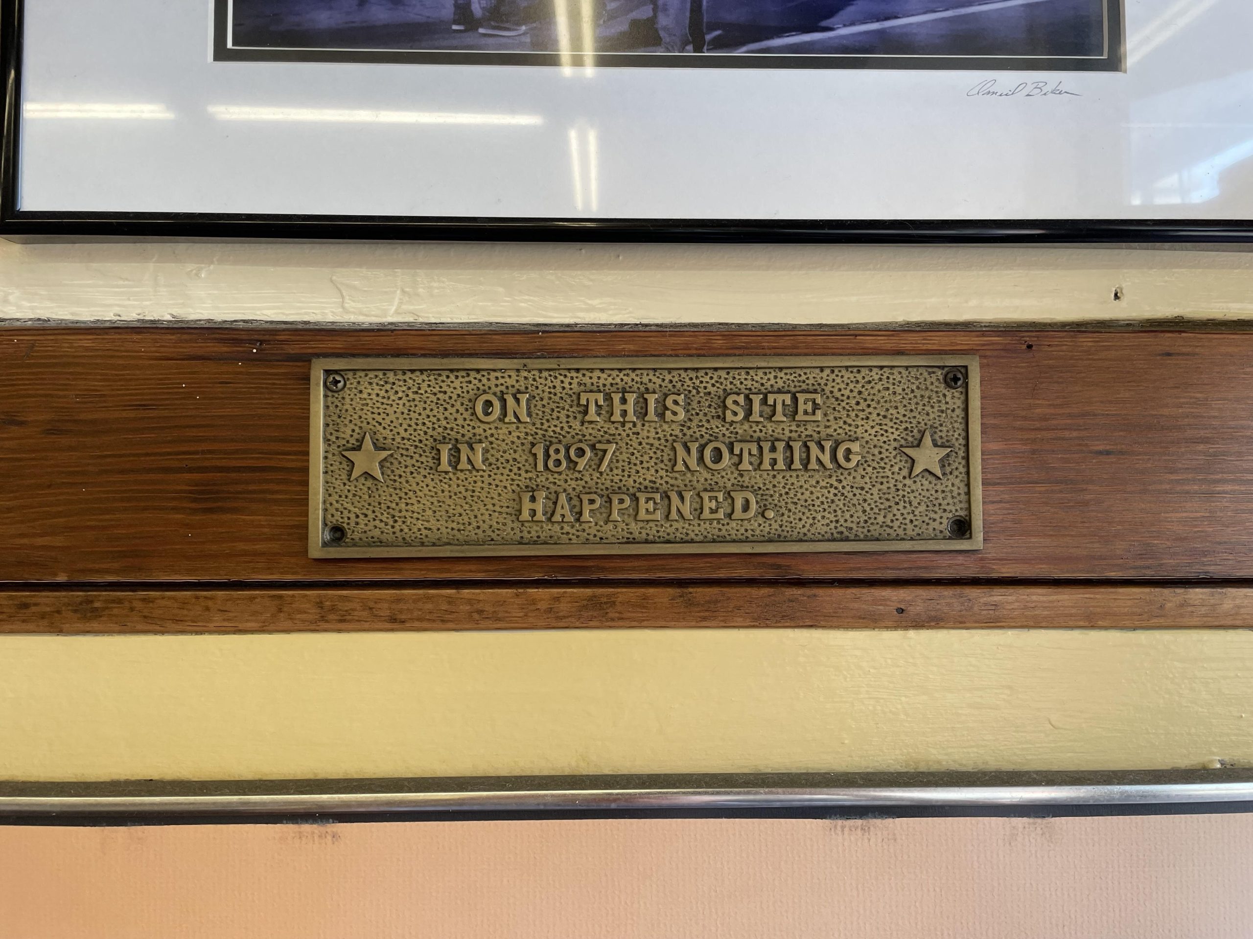 A mysterious plaque near the front door of Coney Island on the West wall.