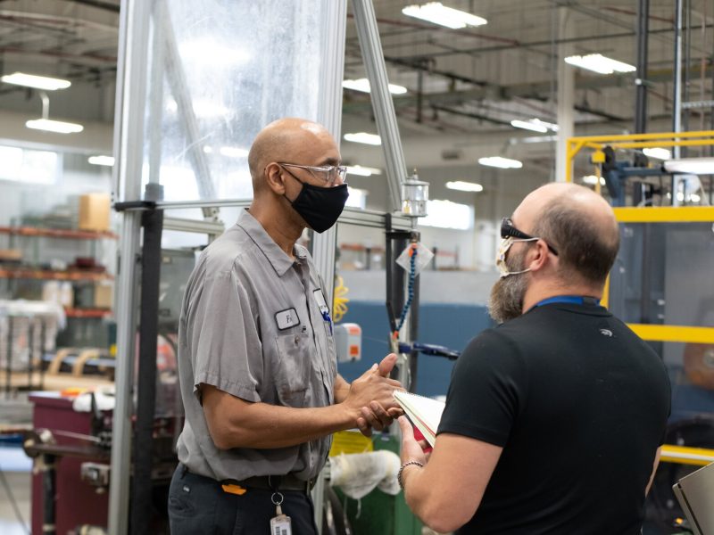 Employees Fred Billingsley, Wiredrawer, left, gives feedback to Clifford Griffith, Engineer Tech in order to improve work at Fort Wayne Metals on Ardmore Ave. on September 27, 2021.