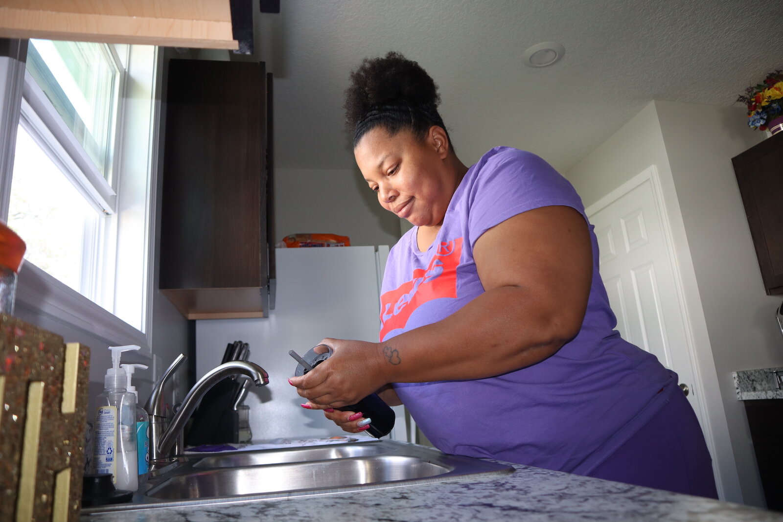 LaPria Taylor works inside her new home in South East Fort Wayne.