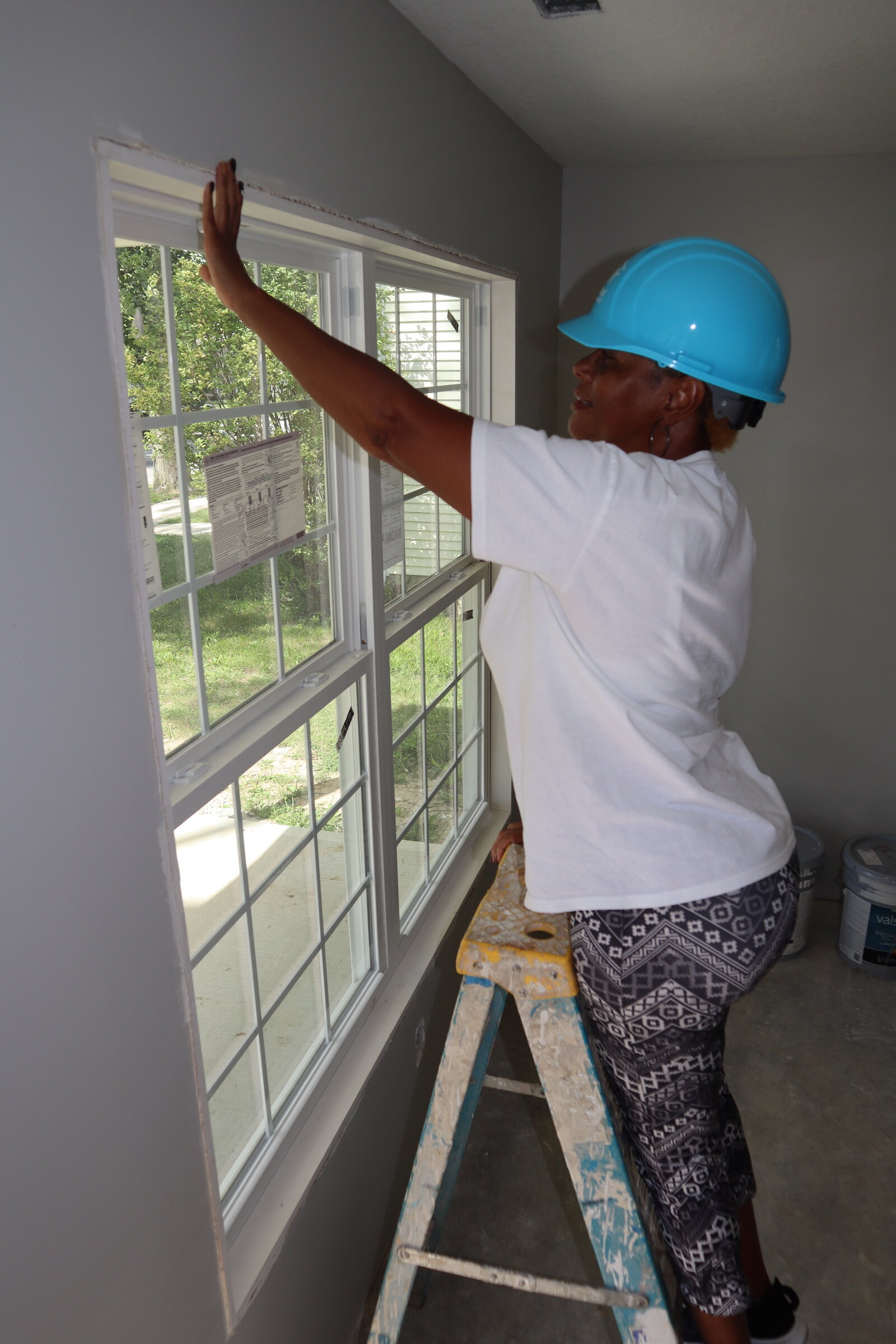 Loretta Taylor helps renovate her home in South East Fort Wayne.