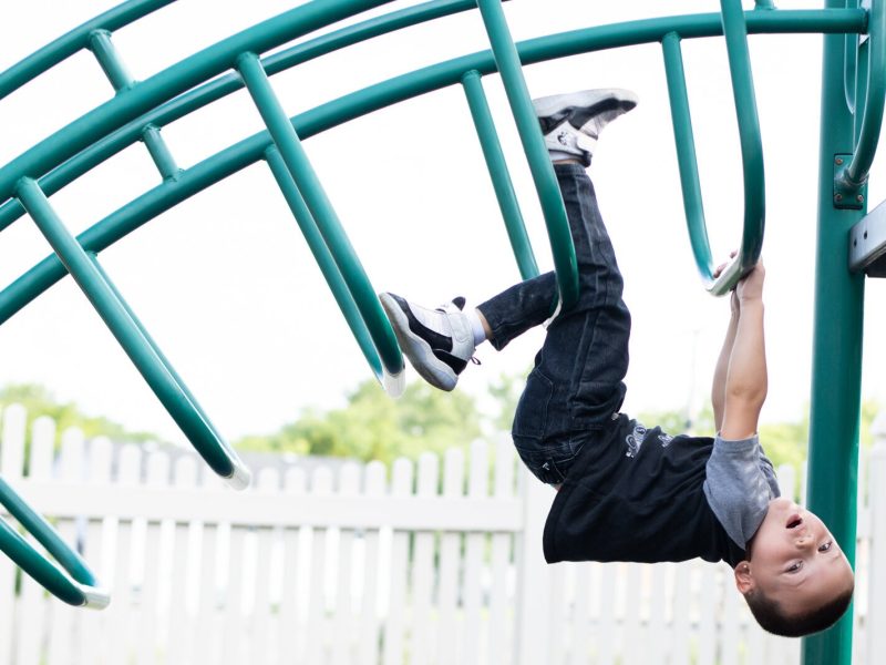 Zaeden climbs on the playground during a 30 minute play time outside during Miss Nielson's 3-5 year old class at Children's Village, 6613 S. Anthony.