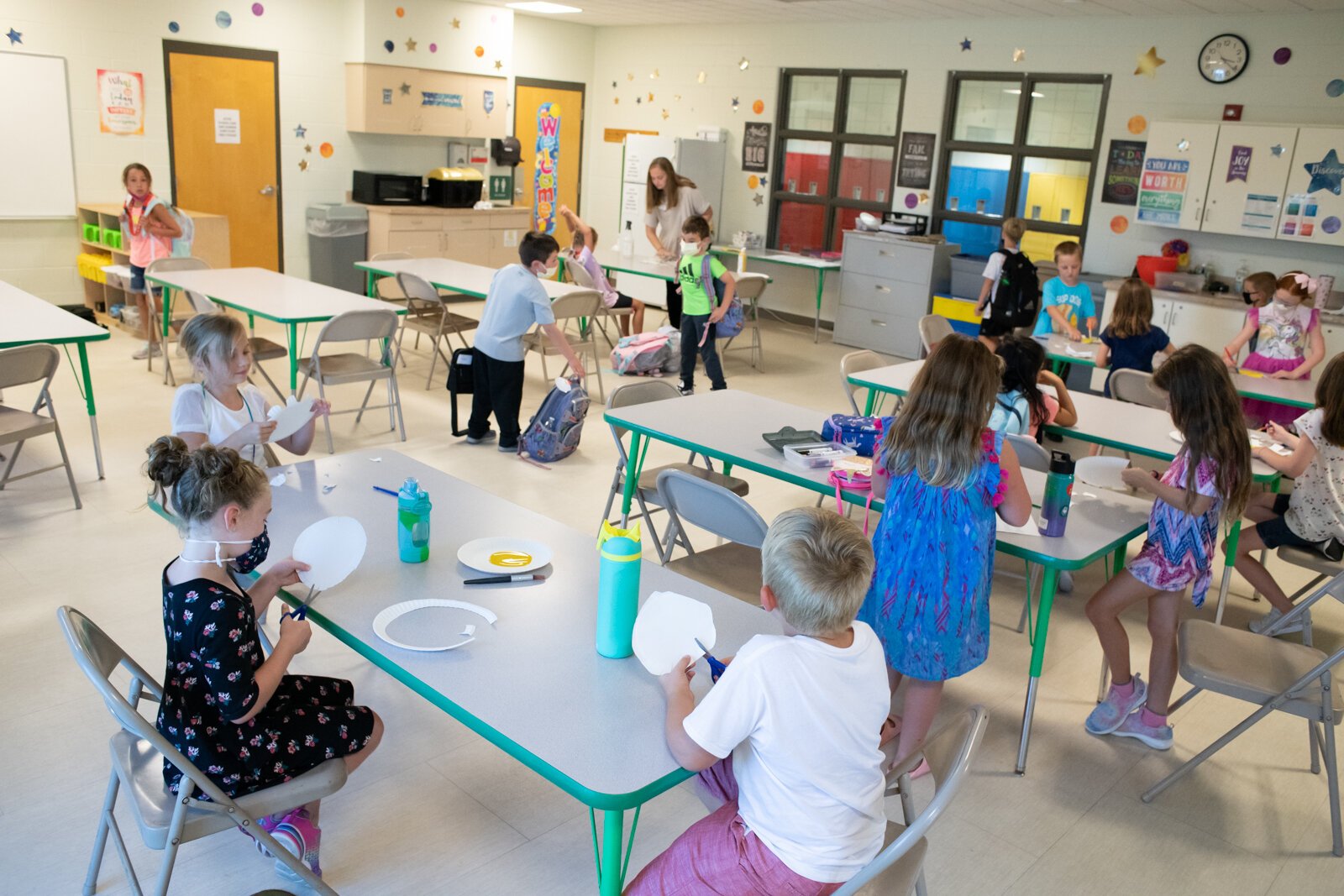 Children work on sunflower art projects in Room A during the Y Care Program at the Parkview Family YMCA, 10001 Dawson's Creek.