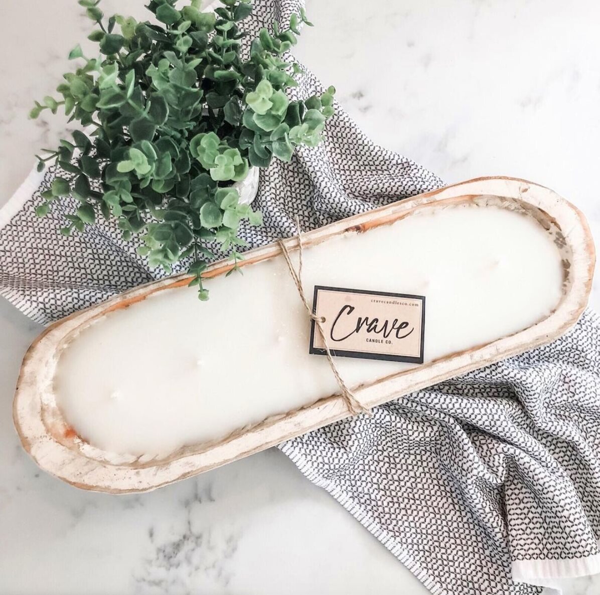 Crave Candles Co. uses recycled bottles from wine and spirits to create soy candles.