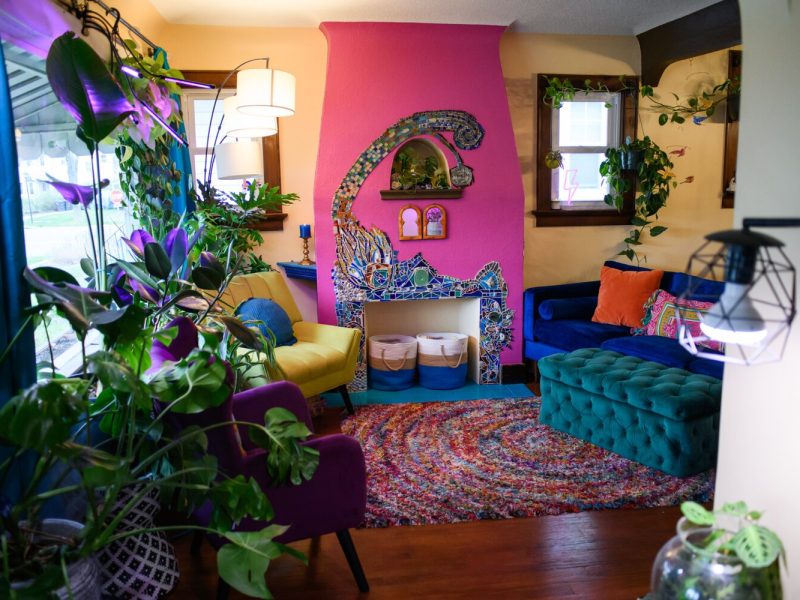 The view from the entry way includes plant and a colorful fireplace into the living room at the Porter family home.