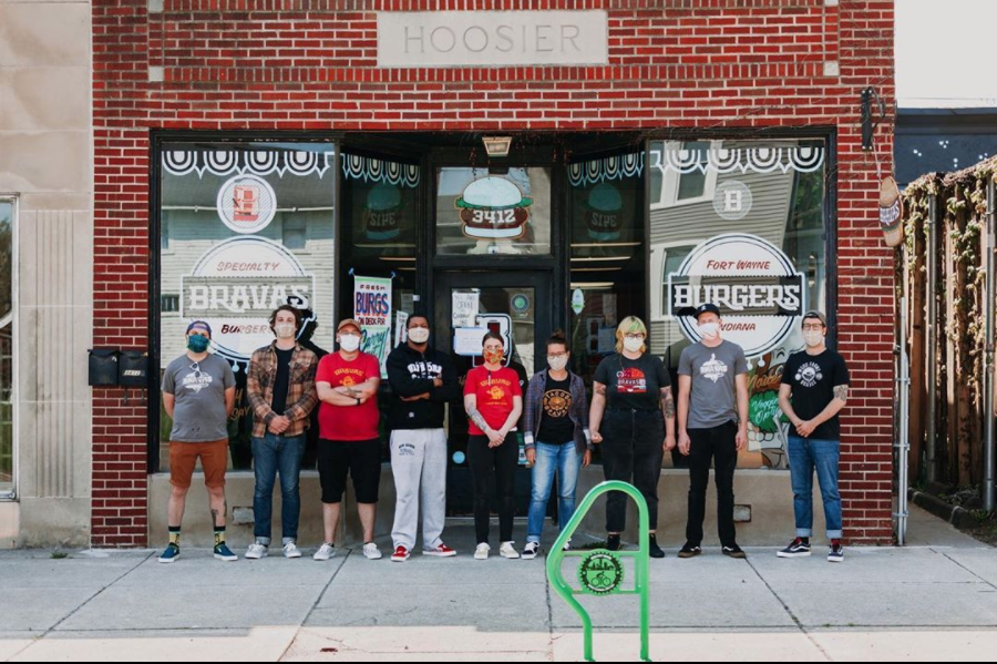 Bravas staff stands in front of the restaurant.