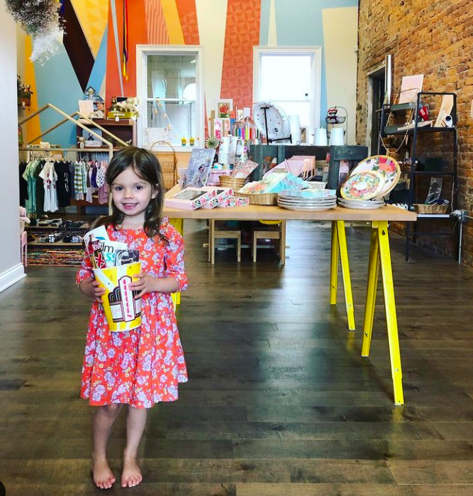 Eleanor enjoys the toy section at Fancy & Staple.