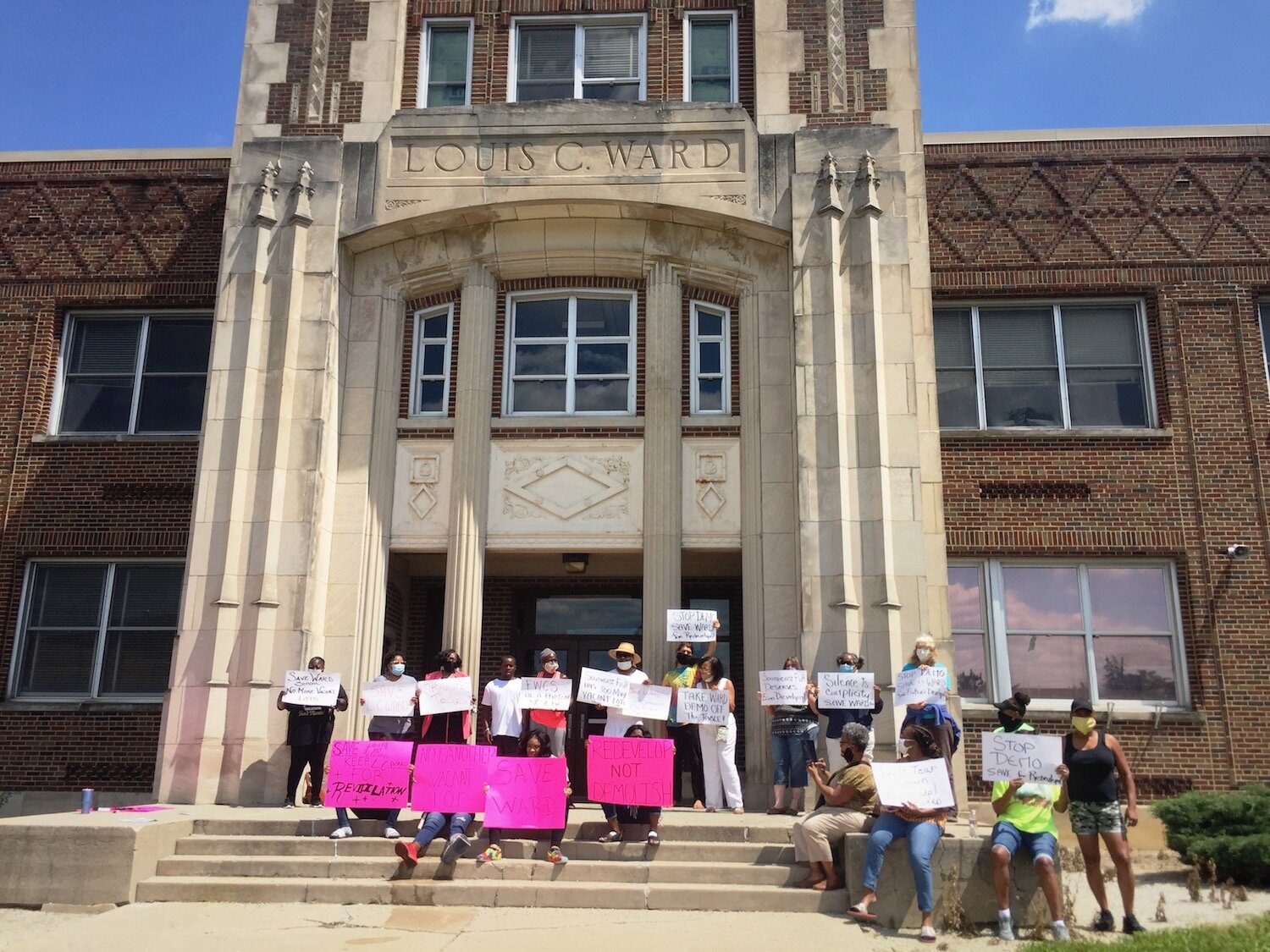 Protesters take to the front steps of Ward School on Friday, Aug. 7, 2020.