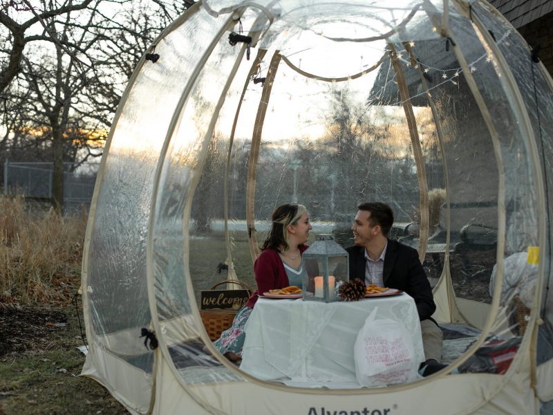 A “Popnic for Two” includes an hour in a heated tent with a decorated table, table setting essentials for a picnic, and a Bluetooth speaker for guest to play their choice of music through.